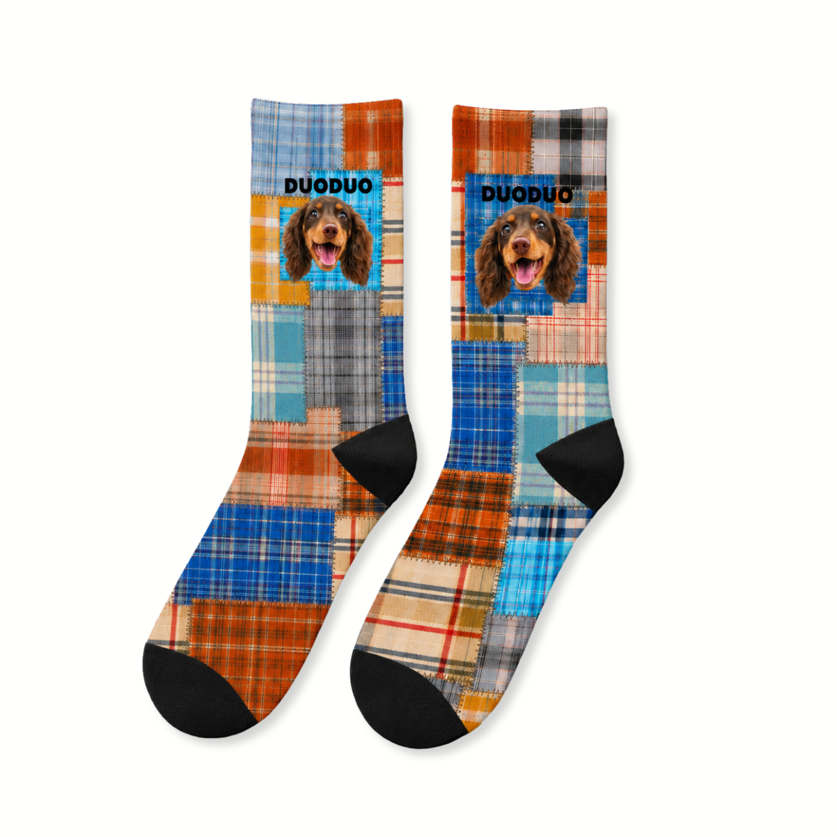 Pair of blue and orange patchwork plaid crew socks laid flat, printed with a dachshund's face and the name DUODUO